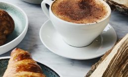 cup of coffee near croissant bread