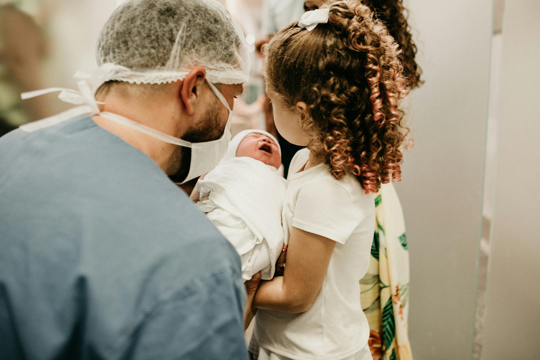 man and child holding baby