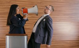 woman shouts on man using megaphone